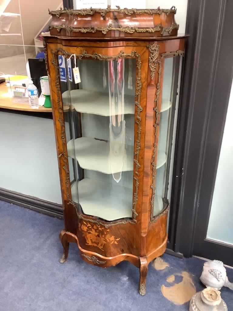 An early 20th century French gilt metal mounted rosewood vitrine, with central serpentine glazed door marquetry inlaid with flowers in a basket, on cabriole legs, width 74cm depth 48cm height 172cm